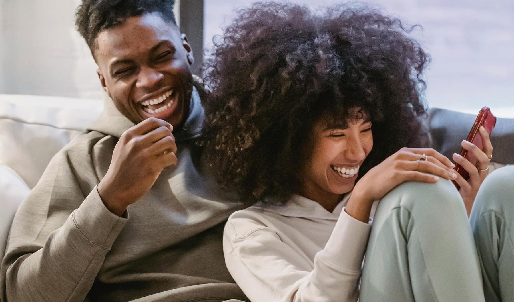 Settle into comfort at Arthouse Apartments a man and woman sitting on a couch